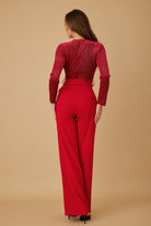 Back view of red wide leg jumpsuit with fitted waist
