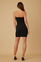 Back view of black strapless mini dress with zipper closure.