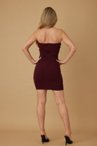 Back view of burgundy strapless mini dress with zipper closure.