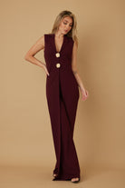 Full length front view of burgundy sleeveless lapel jumpsuit with decorative gold buttons, AVAH