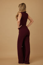 Back three quarter view of Power Move Burgundy Lapel Jumpsuit showing wide leg trouser silhouette, AVAH