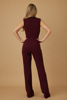 Back view of burgundy wide leg jumpsuit showing back zip closure and full length trouser, AVAH
