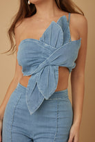 Blue petal wrap top close-up showing draped front detail and asymmetrical strap
