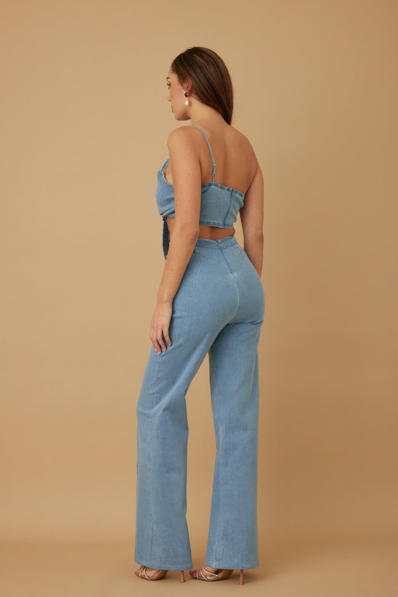 Blue two-piece set back view with zipper top and fitted flare pants
