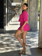 Side view of pink crochet two-piece set showing scalloped hem details

