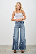 Wide leg jeans worn with white crop top showing high rise fit and relaxed silhouette
