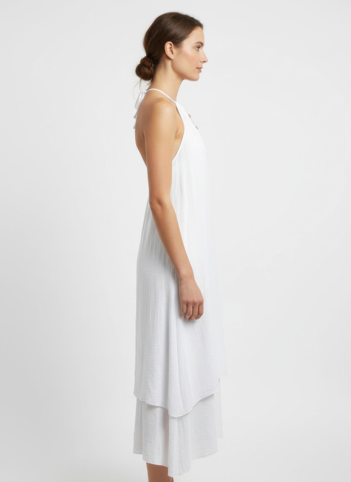 Side view white halter midi dress with flowing layered hem
