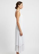 Side view white halter midi dress with flowing layered hem
