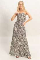 Model wearing beige and black tropical leaf print matching set
