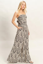 Side view of strapless ruched top with wide leg pants
