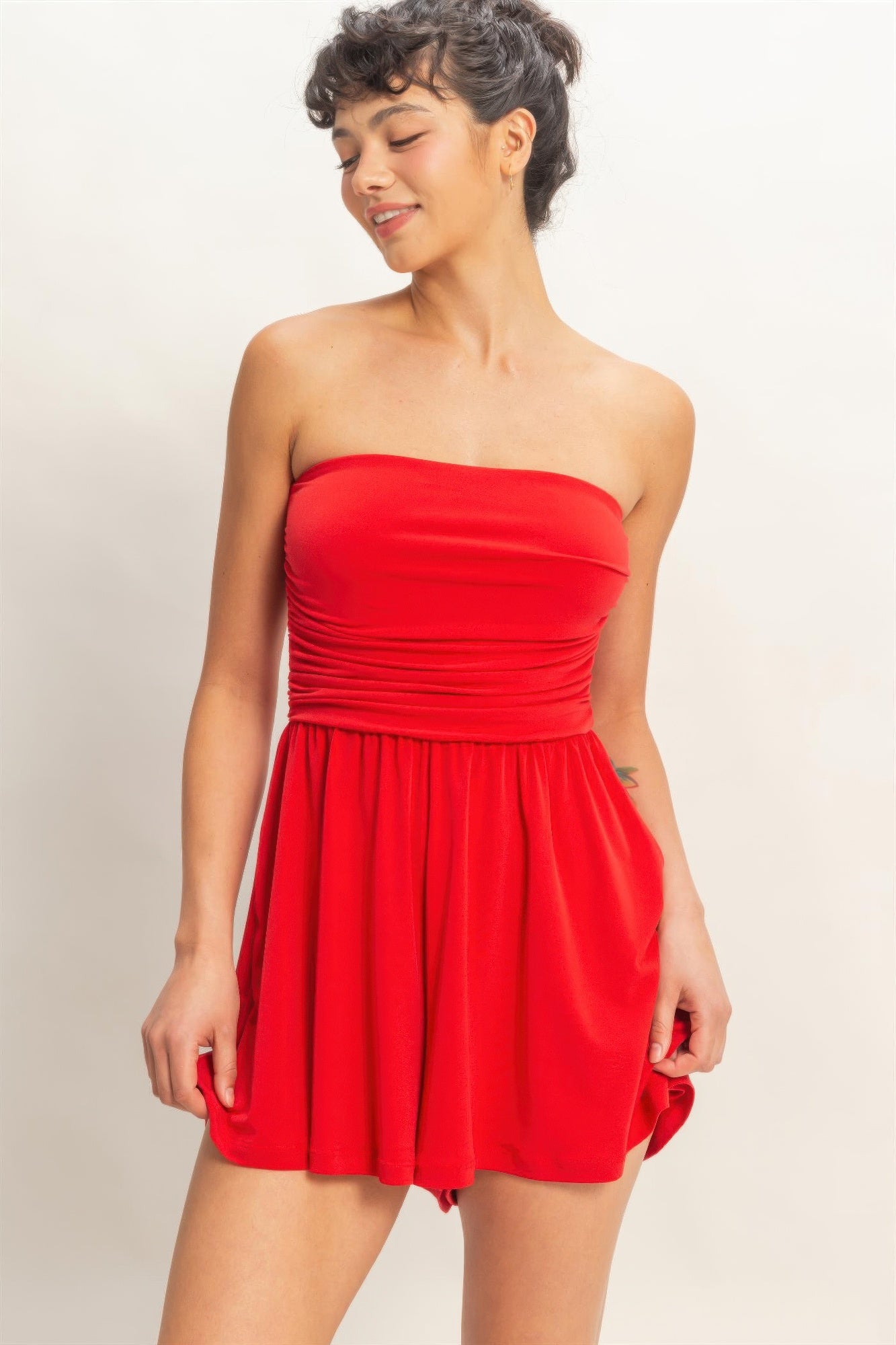 Red strapless ruched romper with flowy skirt overlay front view