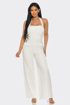 Off white halter wide leg jumpsuit with square neckline, defined waist and faux flap pockets, front view