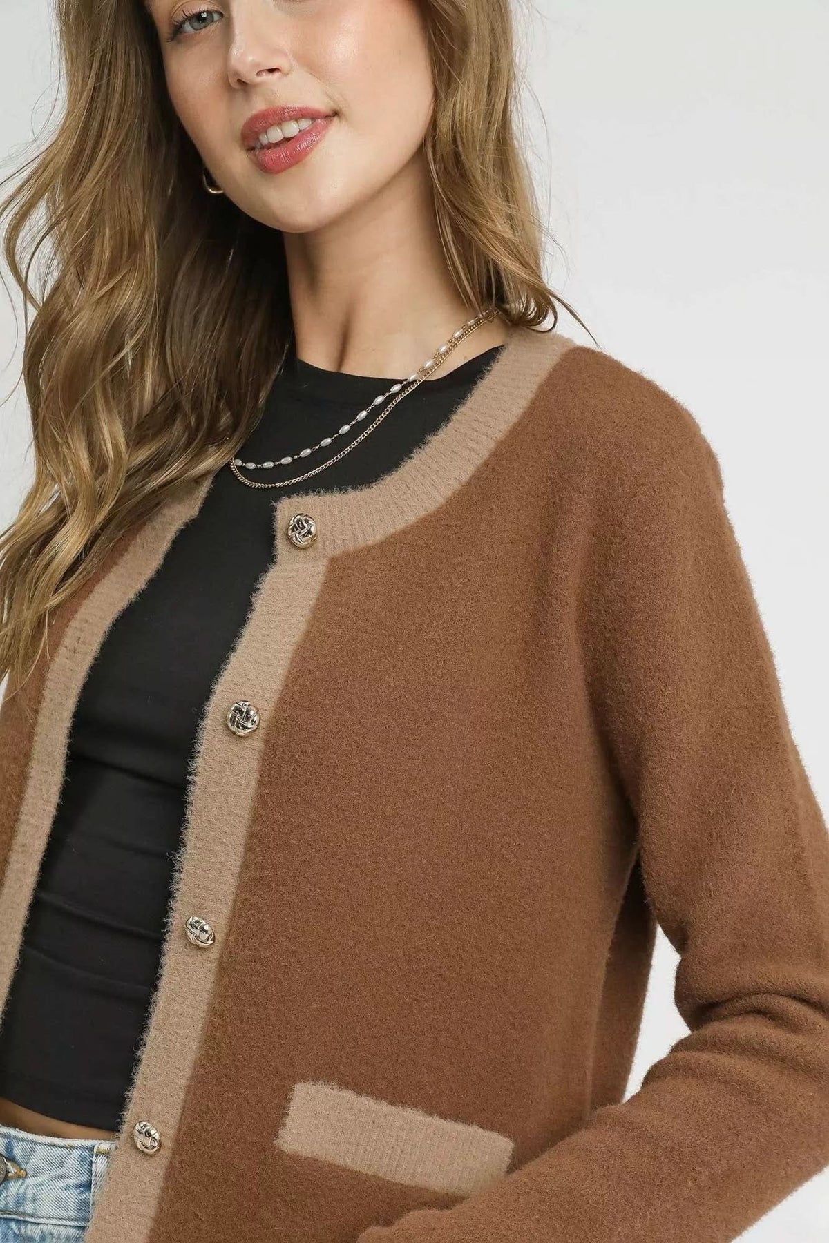 Close-up of Camille Contrast Trim Knit Cardigan featuring gold tone decorative buttons, beige contrast trim and soft textured knit.