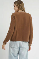 Back view of Camille Contrast Trim Knit Cardigan showing solid brown fuzzy knit, beige neckline trim and hip length silhouette.