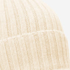 Close-up of an ivory cashmere knitted fabric texture