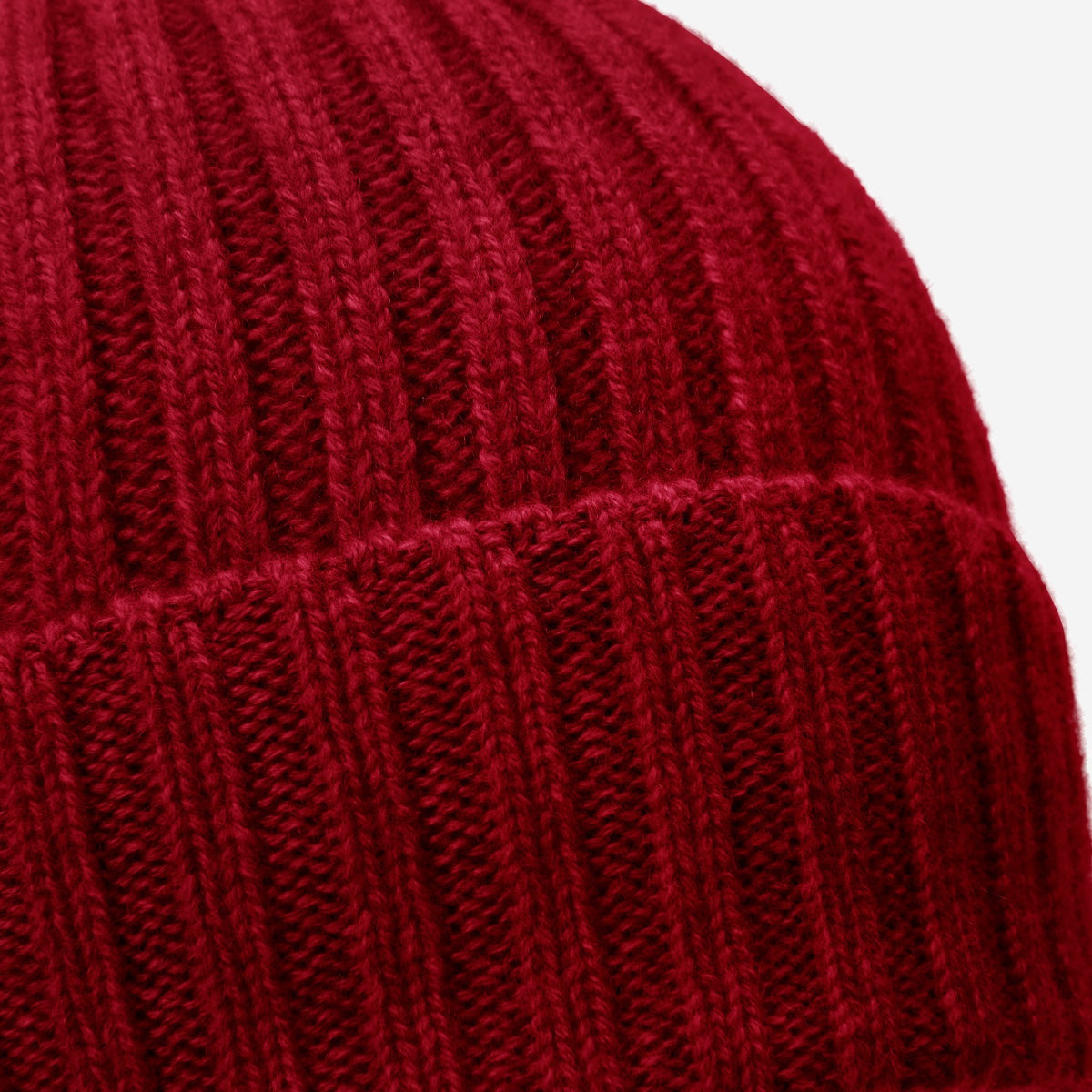 Close-up of a red cashmere knitted beanie with a white background