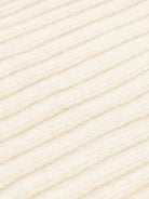 Close-up of cream cashmere fabric texture with horizontal lines