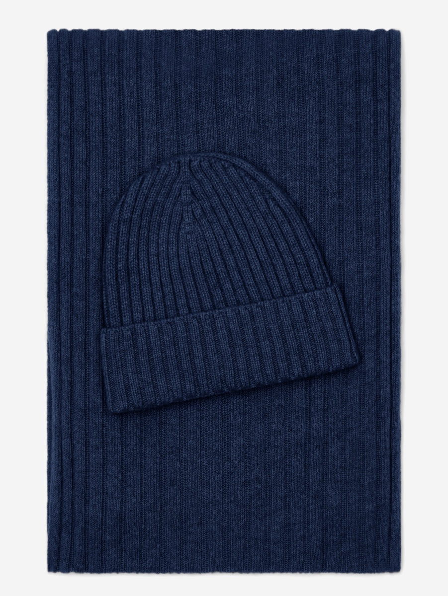 Navy blue knit beanie and scarf set on a white background