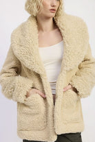 Close-up of beige taupe sherpa teddy coat with oversized collar and pockets

