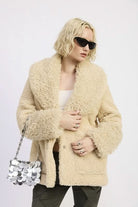 Woman posing in beige taupe teddy coat and dark sunglasses-AVAH