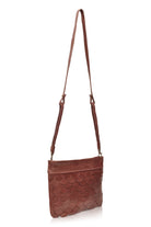 Side profile of the vintage brown Cascade Leather Crossbody Clutch with woven leather strap
