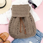 AVAH-closeup of dark khaki woven crochet backpack with brown leather straps