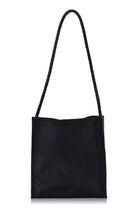Black leather tote bag with a strap on a white background