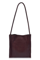 Dark brown leather tote bag with a handle on a white background