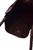 Close-up of a brown leather bag with a button on a white background