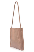 Beige leather tote bag with a rope handle on a white background