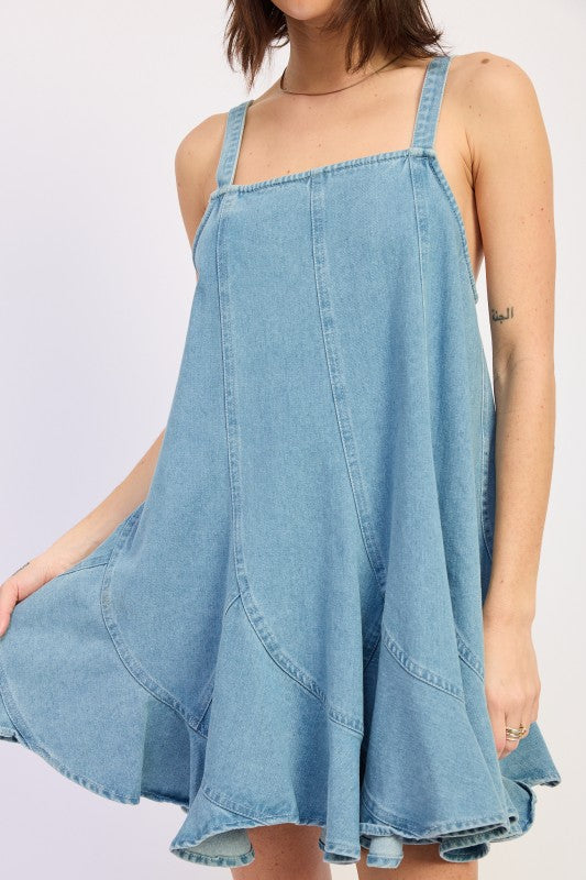 Woman wearing a light blue denim dress against a white background, front view closeup