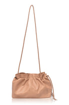 Beige leather crossbody handbag with drawstring top and braided strap on a white background, front view