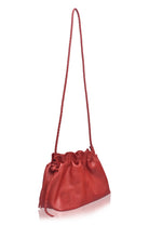 Red leather handbag with a drawstring on a white background