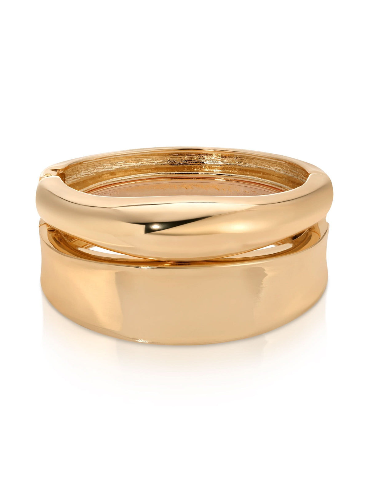 Two polished gold-tone hinged bangles stacked together on white background.