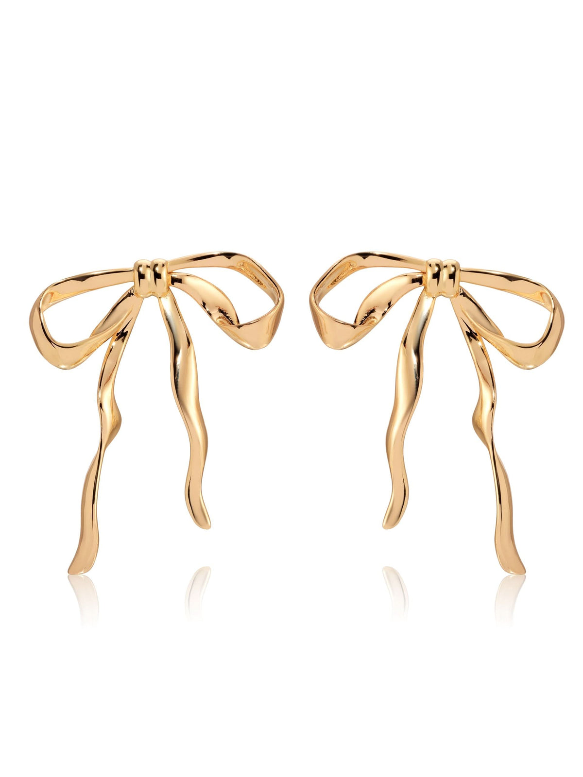 Gold-tone sculpted bow earrings with long wavy ribbon tails on white background.