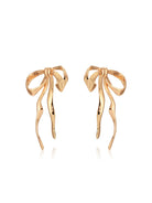 Angled view of gold-tone sculpted bow earrings showing post closures.