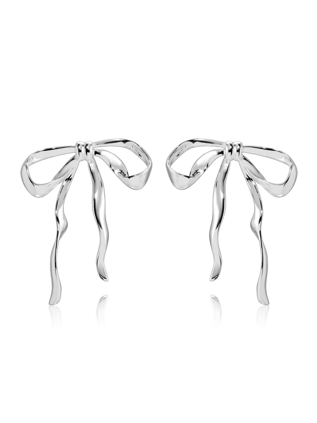 Silver-tone sculpted bow earrings with long ribbon tails on white background.