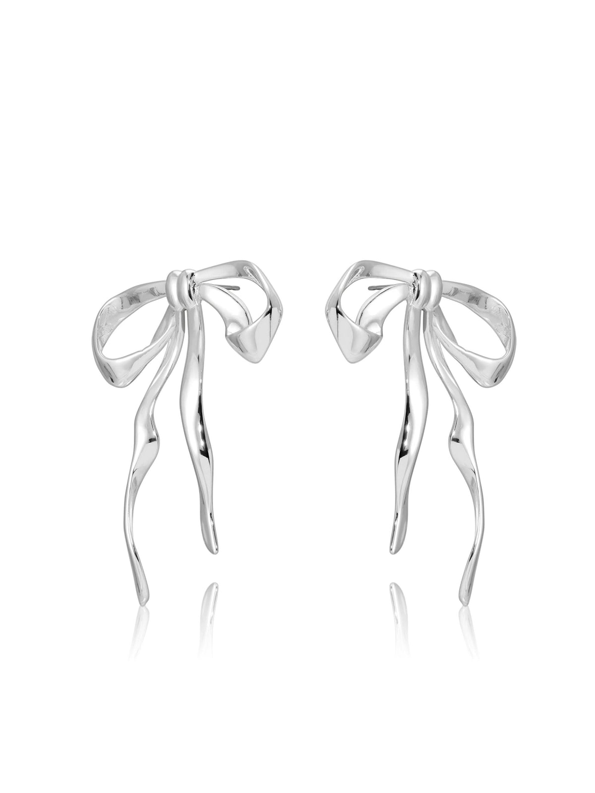 Angled view of silver-tone sculpted bow earrings on white background.