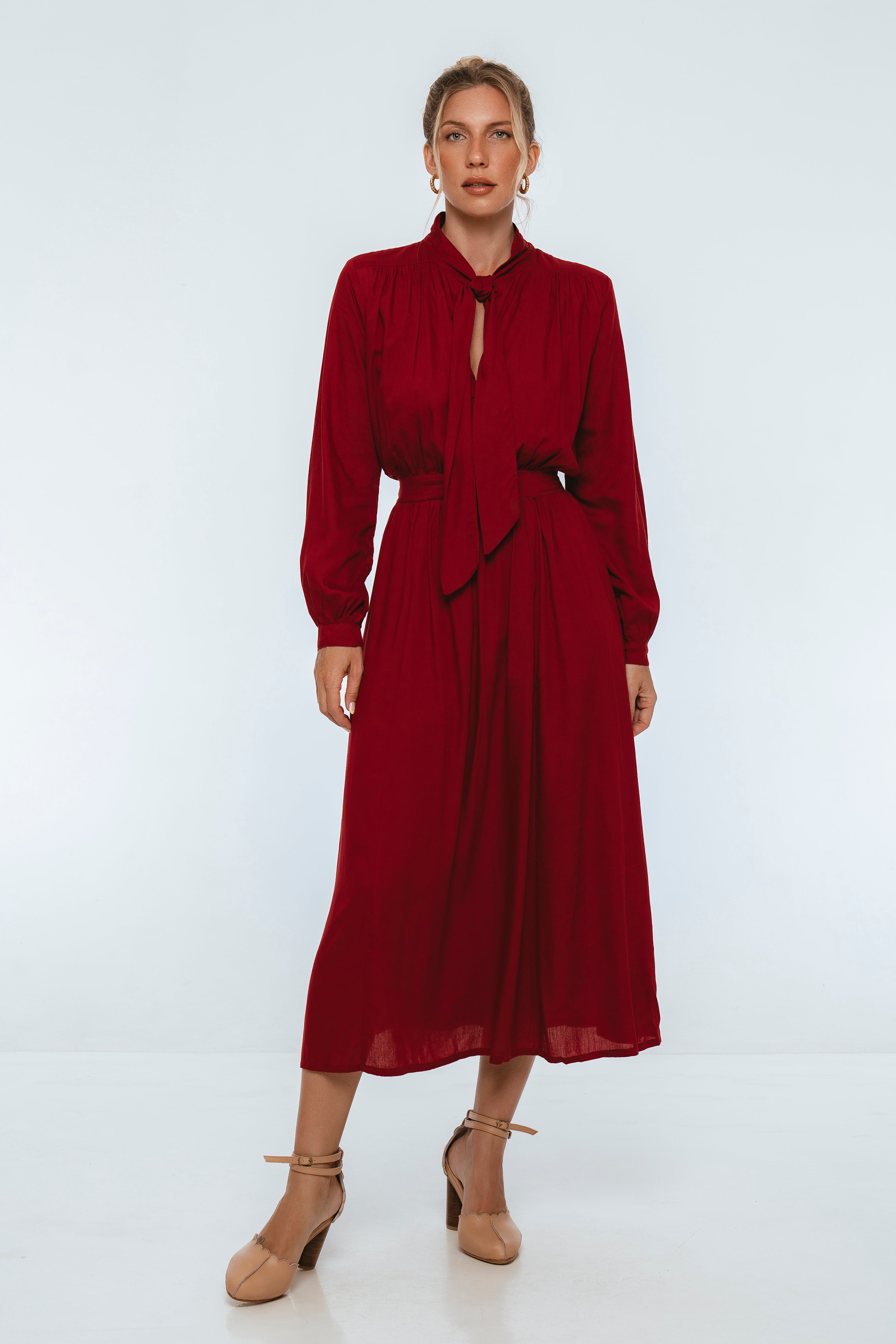 Woman wearing a red dress on a white background