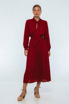 Woman wearing a red dress on a white background