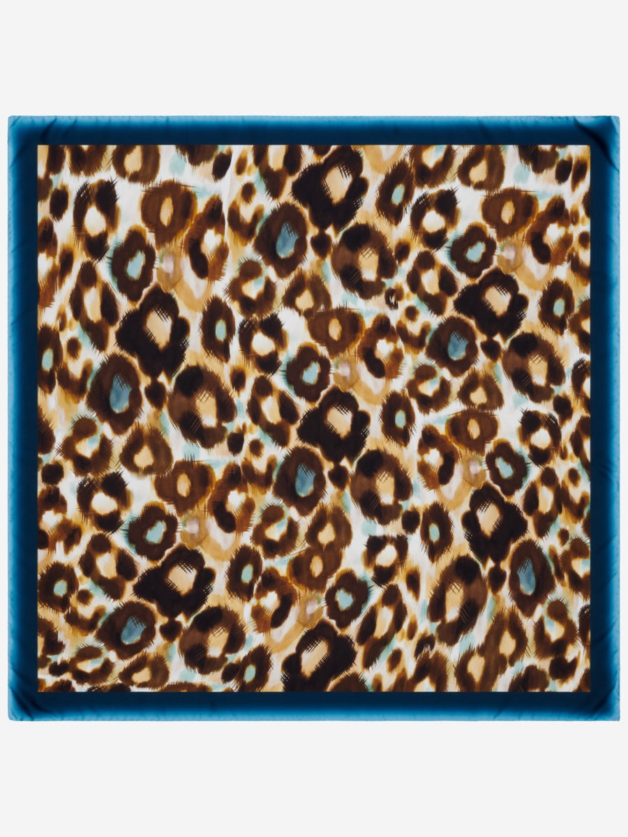 Leopard print pattern with a blue border silk scarf on a white background