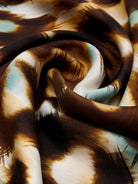 Close-up of fabric with brown and beige abstract pattern