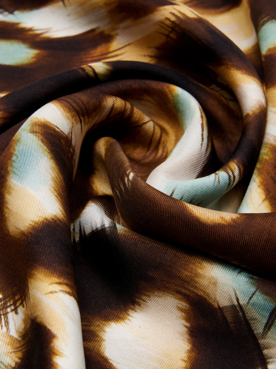 Close-up of fabric with brown and beige abstract pattern