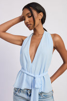 Light blue halter top with deep V neckline and tie waist front view
