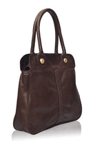 Brown leather handbag with gold buttons on a white background