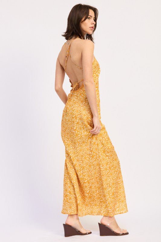 Woman wearing a Tangerine floral halter maxi dress front view fitted silhouette summer dress on a white background