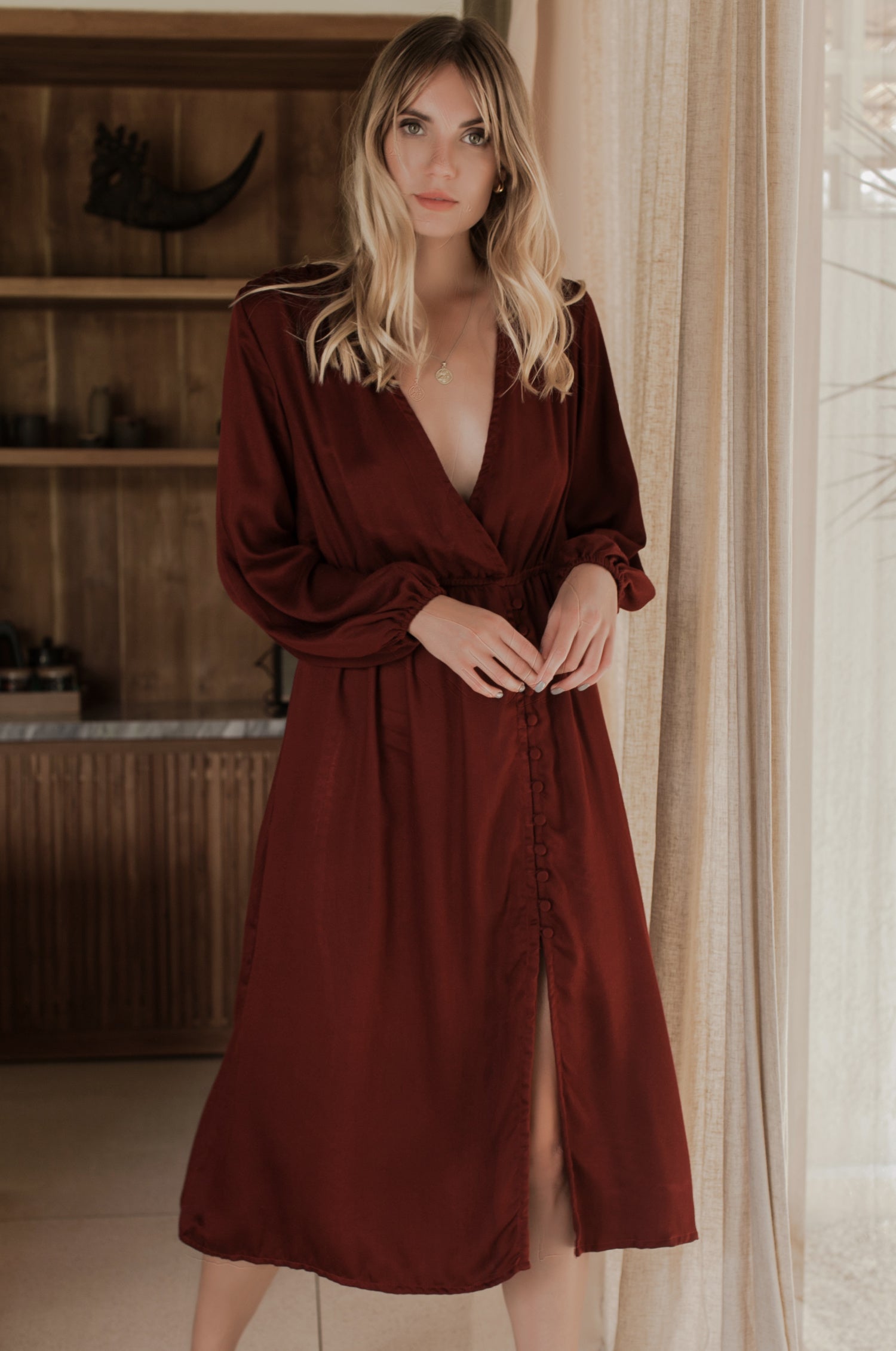Woman wearing a burgundy dress in an indoor setting