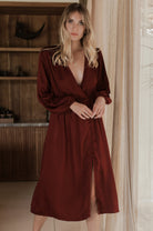 Woman wearing a burgundy dress in an indoor setting