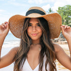 100% straw wide brim sun hat in khaki with Black bow accent