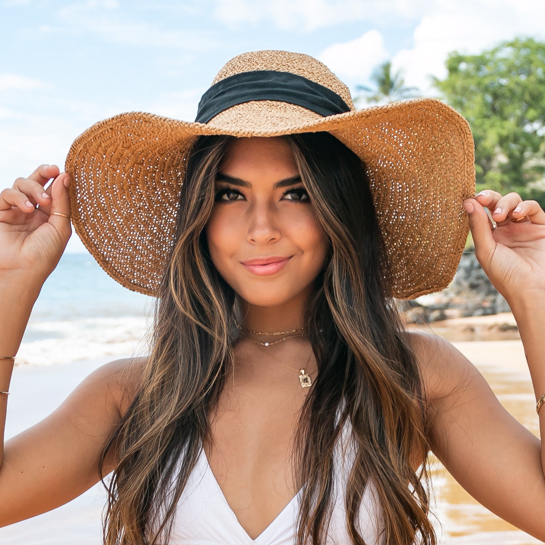100% straw wide brim sun hat in khaki with Black bow accent